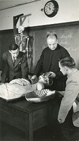 Anatomy laboratory with priest and students