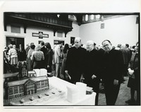 Gasson Hall interior: rededication, Paul Fitzgerald, Charles Finn, and Frank McManus with cake shaped like Gasson Hall