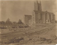 Devlin Hall exterior under construction with horses and wagons by Clifton Church