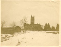 Gasson Hall exterior: front from Commonwealth Avenue during winter with red barn from original property on left