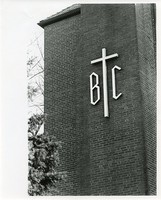 Gonzaga Hall exterior: cross and Boston College initials