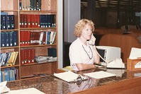 O&#39;Neill Library interior: staff member answering phone at desk