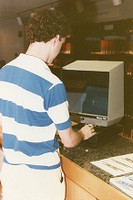 O&#39;Neill Library interior: student standing at microfilm machine