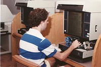 O&#39;Neill Library interior: student using microfilm machine to view the Wall Street Journal