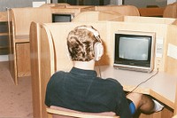 O&#39;Neill Library interior: student with headphones looking at screen