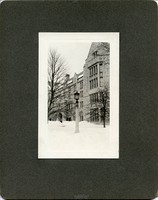Saint Mary&#39;s Hall exterior: front entrance with street lamp in snow, by Clifton Church