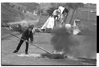 Flying Horse Road, Downpatrick, on the anniversary of internment, children burn tires and block road