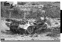 Ballydugan Road, Downpatrick, after Irish Republican Army (IRA) culvert bomb explosion, showing damaged army vehicle and scene