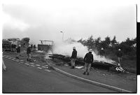 Firefighters putting out potential arson fire in travelers&#39; caravan and portacabin, and traveler children, Flying Horse Road, Downpatrick