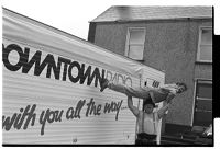 Dave &quot;Mighty&quot; Parkinson lifting Tommy Sands above his head in front of Downtown Radio truck