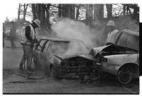 Police and firemen at a car crash and fire, Seaforde, County Down