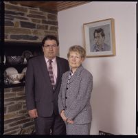 John Hume, with wife Pat and a portrait of himself by Derek Hill