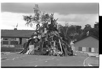 Children climbing pile of wood before 12th of July bonfire